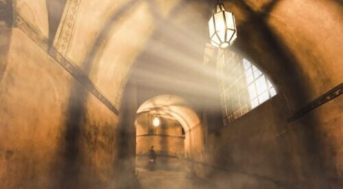 light from the lamp and the shadows in the mysterious corridor in the old dungeon